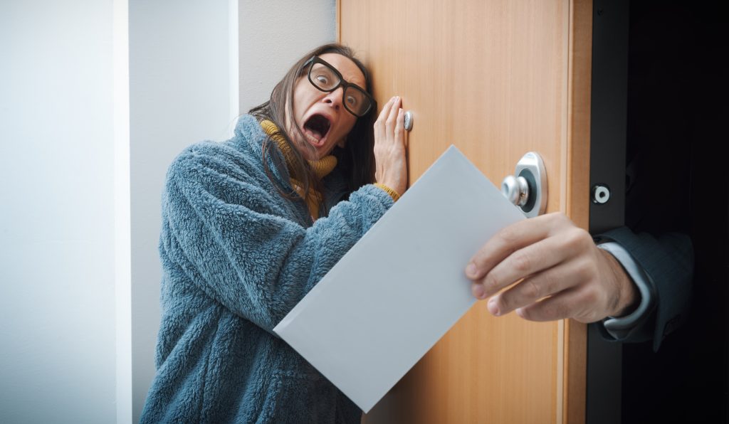 Terrified woman receiving eviction notice